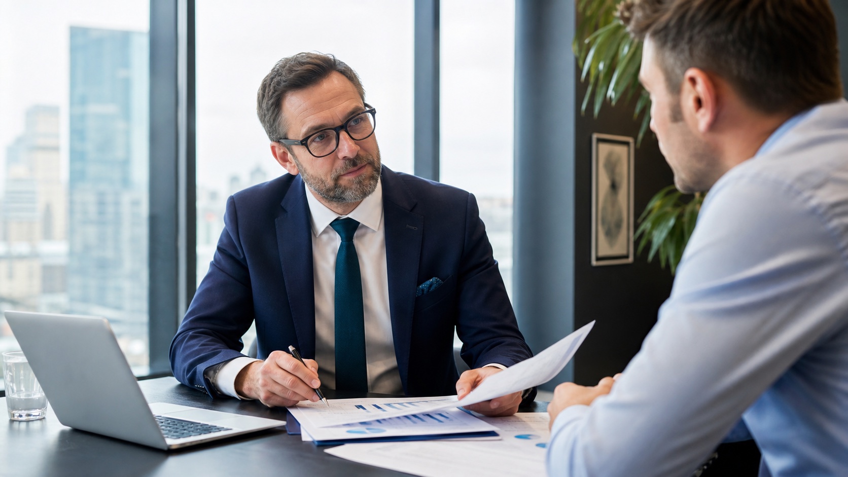 Accountant reviewing annual accounts with a client in a modern meeting room